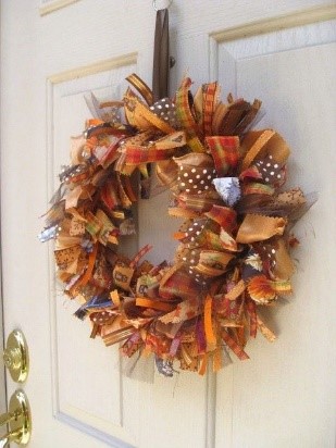 A wreath on a door

Description automatically generated